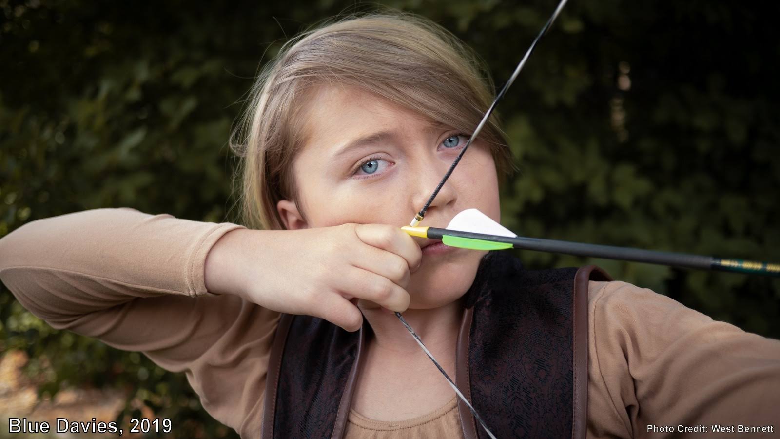 blue holding bow and arrow